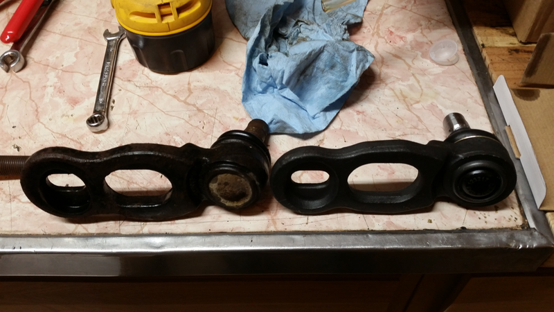 Eccentric nuts ride in the cutouts on the cast part, the one nearer the balljoint sets caster and the other sets the camber by moving the balljoint on the upper control arm. It’s pretty clever and works very well - there is a lot of adjustment possible.